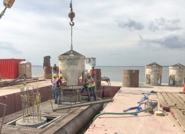 workers guiding crane lifting equipment SH 334 Bridge